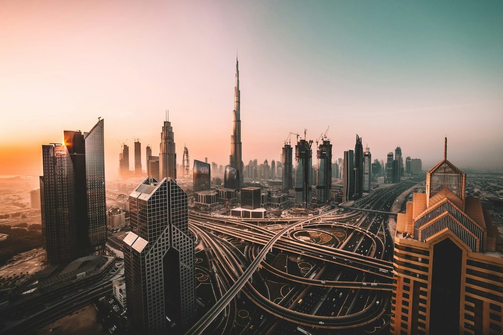 Dubai skyline at sunset with Burj Khalifa and residential towers, where owning property can qualify buyers for a UAE residence visa