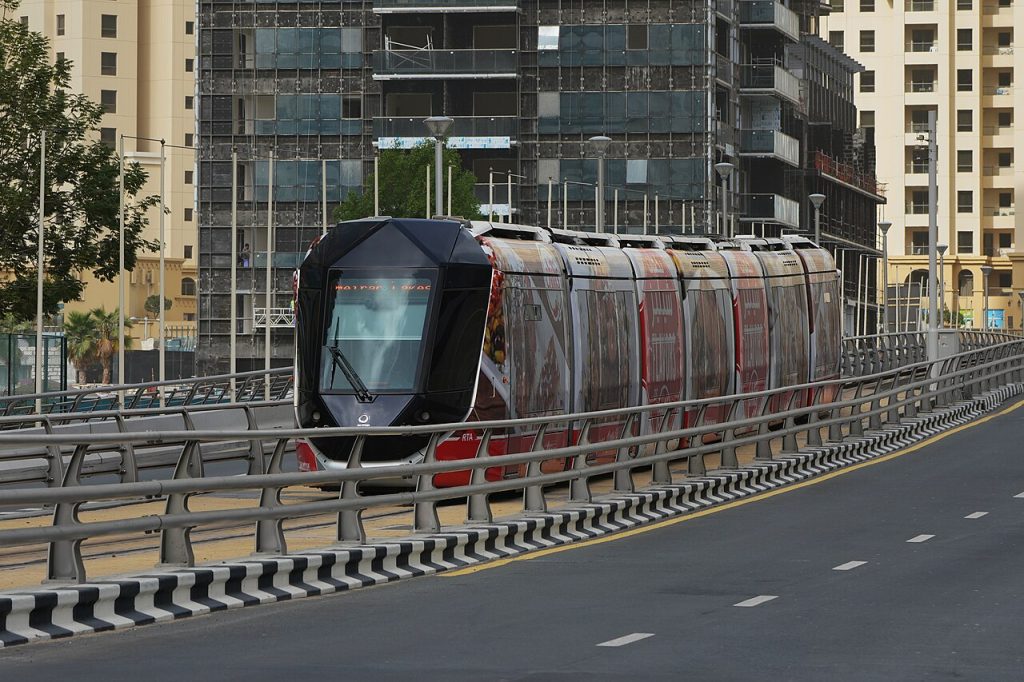 Dubai Tram modern streetcar traveling through Dubai Marina surrounded by skyscrapers