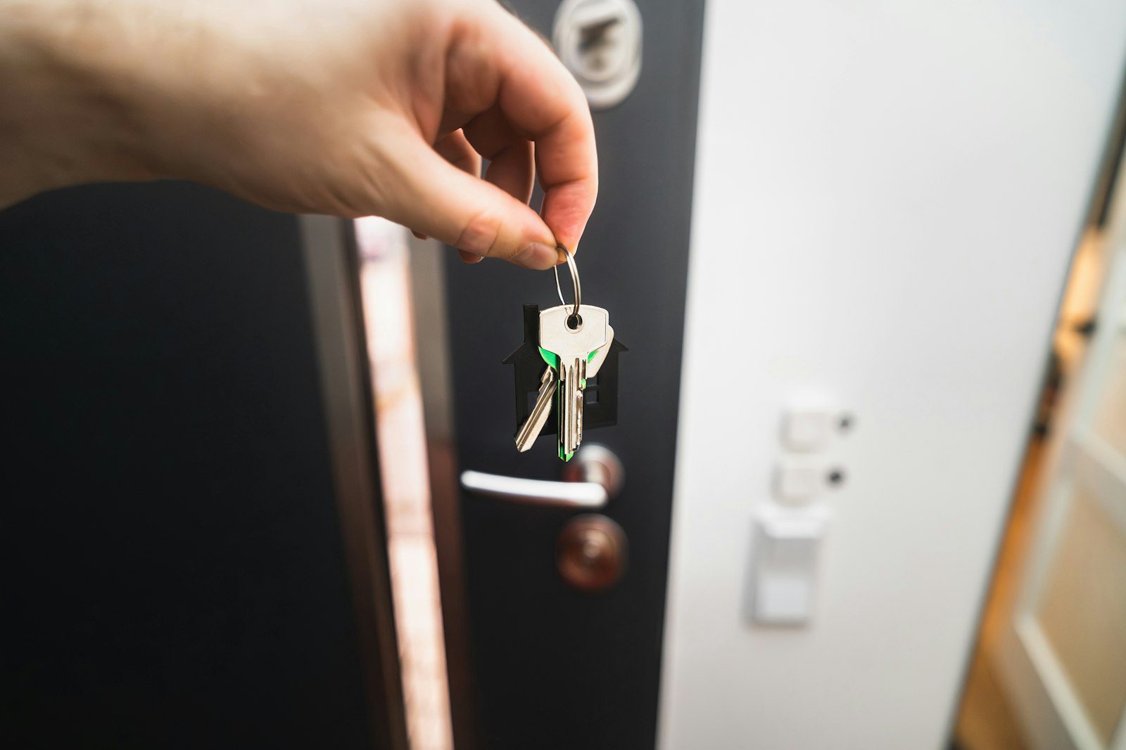 Key being turned in an apartment door, illustrating shared title deeds and residence visa eligibility in Dubai