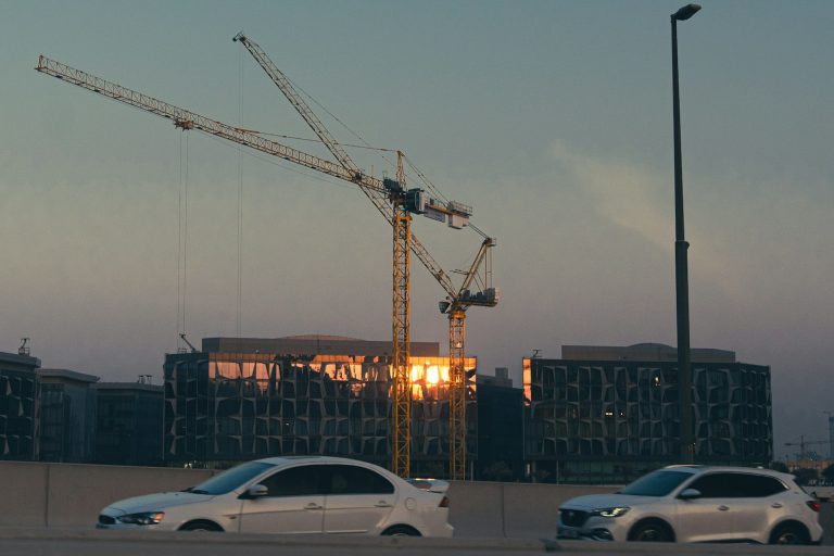 Construction cranes over a Dubai residential project, the type of off-plan property used for Golden Visa applications