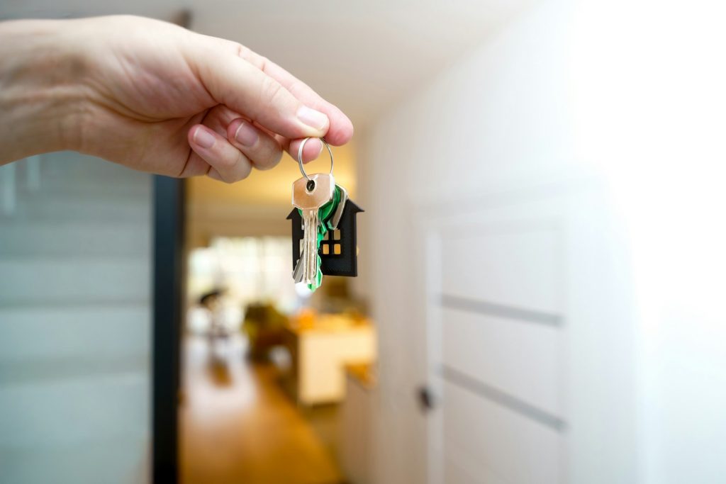 Hand holding house keys, representing a Dubai home bought with a mortgage