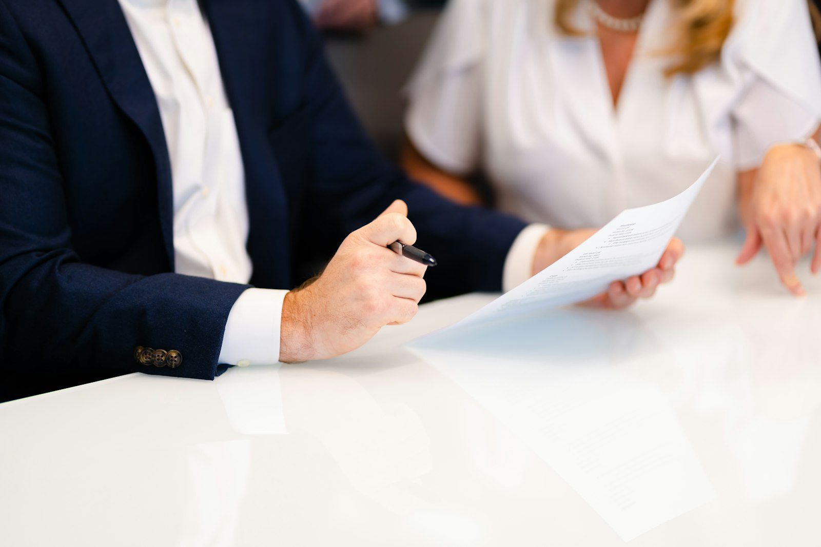 Buyer and bank adviser signing documents, the step where a Dubai lender issues a NOC for a property visa