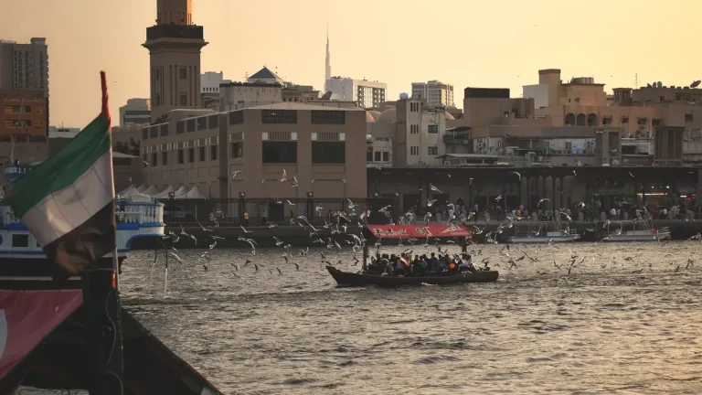 Traditional wooden abra boat crossing Dubai Creek with passengers